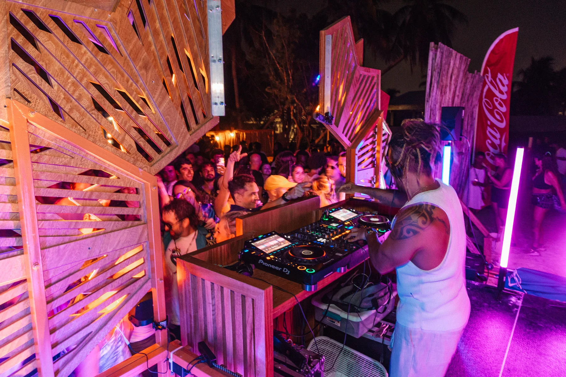 Tiago Black playing to a crowd from the DJ booth